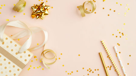 Celebration background with gold confetti and decorations, gift, drinking straws. Birthday party...