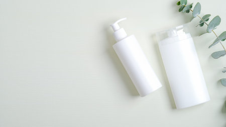 Cosmetics SPA branding mockup. Bath shampoo or shower gel bottle, hair lotion and eucalyptus leaves....