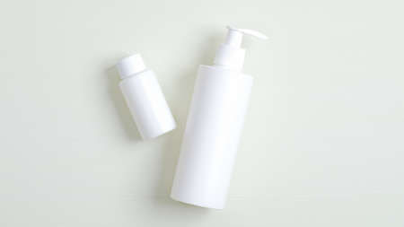 White plastic bottle with pump and essential oil for hair container branding mockup. Cosmetics SPA, shampoo and lotion packagingの写真素材