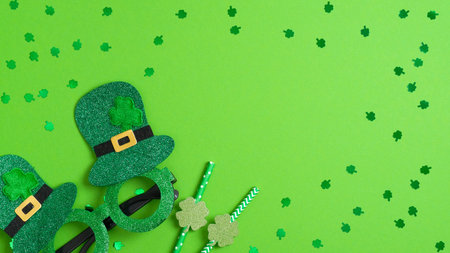 St Patricks Day Banner. Top view glasses with leprechaun hats and drinking straws with shamrock on...
