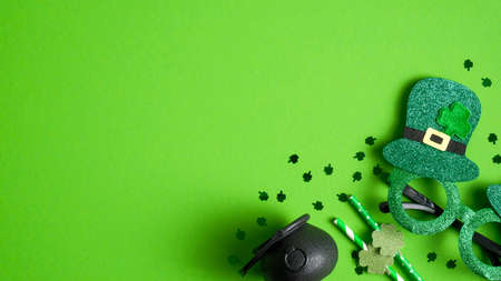 St. Patrick's Day header or banner design with pot of gold, St. Patrick's Day green glasses, drinking straws decorated shamrock leaf clover, confetti. Happy Saint Patricks Day conceptの写真素材