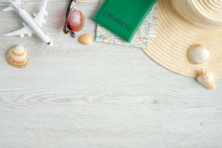 Travel accessories frame top border. Flat lay airplane model, sunglasses, passport document, map, beach hat and seashells. Travel summer holiday vacation concept. Travel agency banner designの写真素材