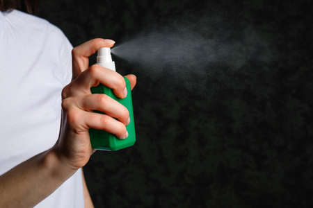 Antiseptic spray or sanitizer in female hand. Coronavirus Disease (Covid-19) prevention concept.の写真素材