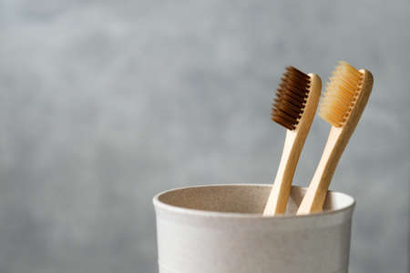 Natural organic bamboo toothbrushes in glass holder, close up view. Zero waste, plastic free, eco friendly equipment for oral personal hygiene.の写真素材