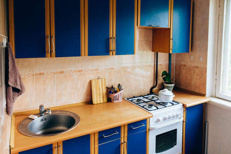 Retro simple kitchen interior design with ugly messy cabinets in need of remodel.の写真素材