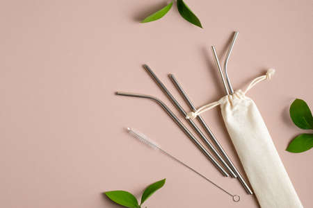 Reusable drinking straws made of stainless steel metal with case. Flat lay, top view. Zero waste, plastic free concept. Sustainable lifestyle.の写真素材