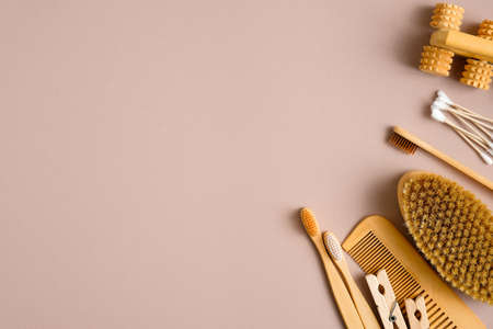 Eco-friendly hygiene products bathroom accessories on brown background. Top view bamboo toothbrushes, wooden hair comb, cotton ear sticks, spa brush. Zero waste, plastic free conceptの写真素材