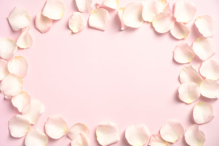 Frame border made of rose petals on pastel pink background. Happy Valentines Day greeting card mockup, banner design. Top view with copy space, flat lay.の写真素材
