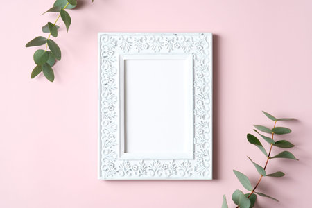 Photo frame mockup and eucalyptus leaves on pink background. Happy Mothers Day, love, romance concept.の写真素材