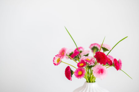 Pink spring flowers in vase on white background, closeup view.の写真素材