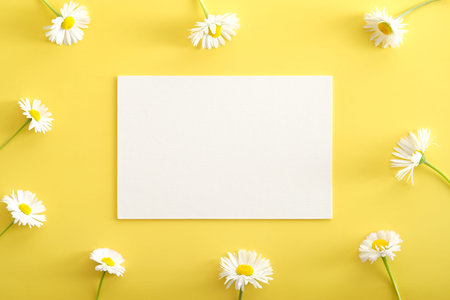 Chamomiles flowers and white paper card mockup on yellow background. Happy Mother's Day, Women's...