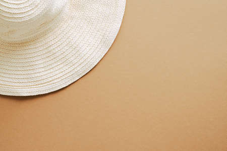 Flat lay straw hat on sandy color background. Top view, overhead. Summer, vacation conceptの写真素材