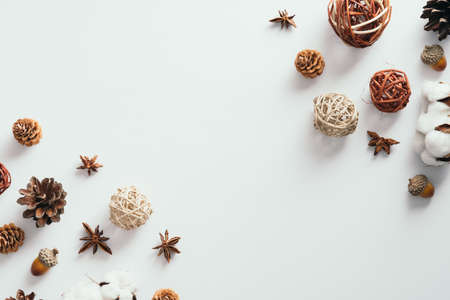 Autumn flat lay composition. Frame made of pine cones, cotton, decorations on white background. Autumn, fall, Thanksgiving conceptの写真素材