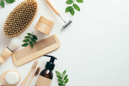 Set of eco friendly SPA bathroom accessories and cosmetics with green leaves on white background. Sustainable lifestyle, plastic free concept. Flat lay, top view.の写真素材