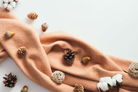 Autumn flat lay composition with brown scarf, pine cones, cotton, acorns on white background. Top view, overheadの写真素材