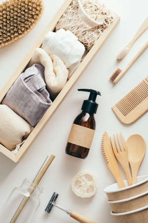 Zero waste eco-friendly accessories set. Flat lay amber glass dropper bottle, eco bags, wooden toohbrushes, hair comb. Flat lay, top view.の写真素材
