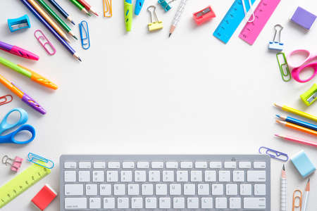 School supples and keyboard on white background. Flat lay, top view colorful stationery. E-learning, online school concept.の写真素材