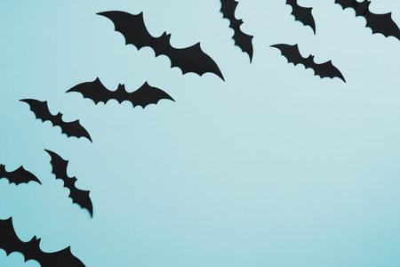 Halloween bats decorations on blue background. Happy Halloween holiday banner design. Flat lay, top...