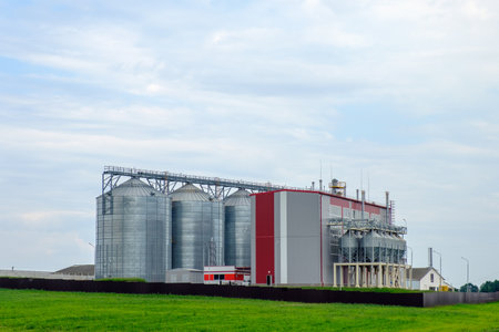 Agribusiness concept. Agro-processing and manufacturing plant with metal silos for grain storage, drying, cleaning agricultural products, flour, cereals and grainのeditorial素材