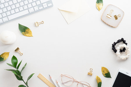 Elegant feminine workspace with keyboard, glasses and office supplies on white background. Flat lay,...