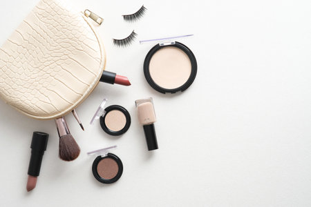 Make-up bag with cosmetics and accessories on white background. Flat lay, top view.の写真素材