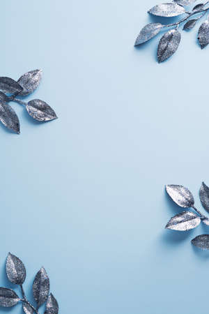 Frozen branches on blue background. Christmas or New Year vertical banner design. Minimal style.の写真素材