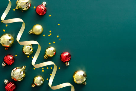 Christmas frame with shiny balls and decorations on green background. Flat lay, top view, overhead. Happy New Year greeting card template, Xmas banner design.の写真素材