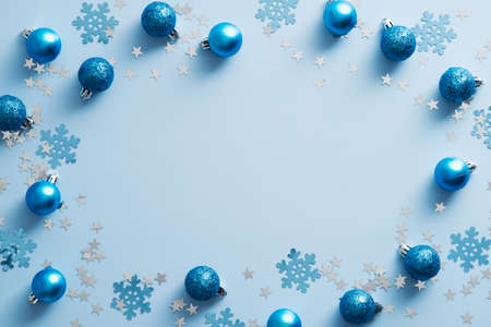 Blue Christmas background with balls and snowflakes. Christmas frame. Flat lay, top view.の写真素材