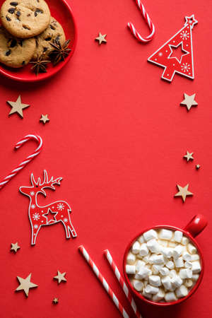Vintage Red Christmas background with oatmeal cookies, candy canes, hot cocoa with marshmallow. Flat lay, top view.の写真素材