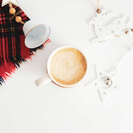 Christmas or New Year cozy holiday composition with cup of hot chocolate, nordic decorations, scarf on white desk table. Hygge, Scandinavian style Christmas aesthetic.の写真素材