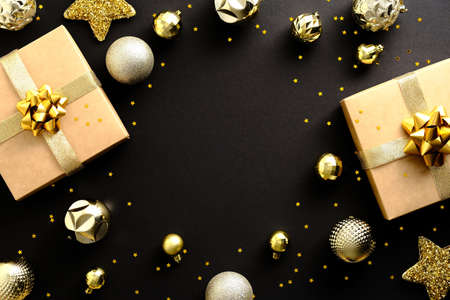Black Christmas background with gift boxes, golden Xmas decorations, confetti. Creative design greeting card, banner.の写真素材