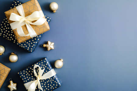 Christmas blue background with gifts and Xmas ornaments. Flat lay, top view, copy space. Merry Christmas and Happy New Year greeting card design.の写真素材