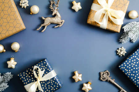 Blue Christmas background with Christmas decorations, gift boxes, baubles, stars. Flat lay, top view. Xmas banner mockup.の写真素材