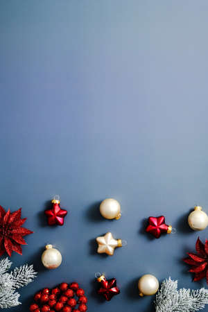 Christmas decorations and fir branches on blue background. Vertical Christmas banner design.の写真素材