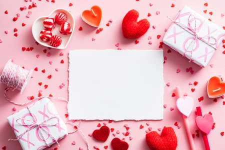 Happy Valentines Day greeting card design. Top view blank paper card, gifts, ribbon, confetti on pink background. Love, romance conceptの写真素材
