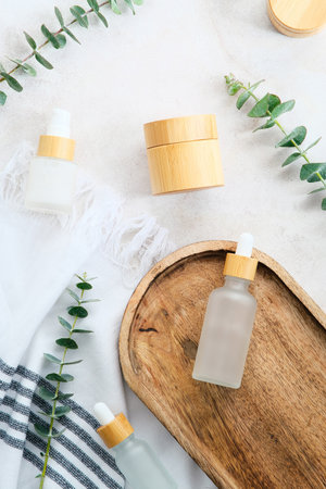 SPA natural beauty products set and eucalyptus leaves on stone table.の写真素材