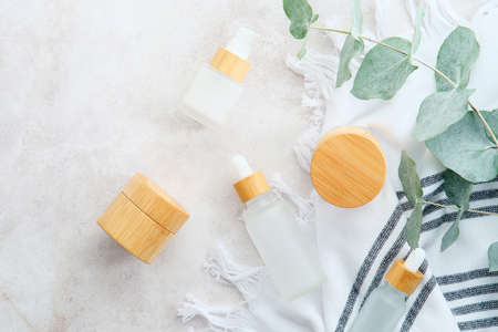 Natural organic SPA cosmetics products set with green eucalyptus leaves. Top view herbal skincare beauty products on stone table.の写真素材