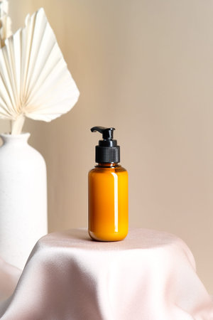 Soap gel dispenser bottle on satin fabric podium. SPA beauty product designの写真素材