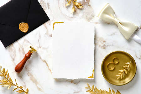 Elegant wedding invitation card template. Flat lay, top view luxury wedding stationery set on marble gold background.の写真素材