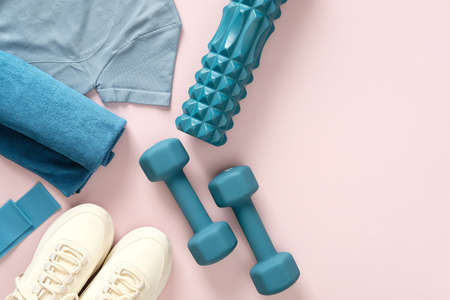 Female fitness flat lay, sneakers, dumbbells, on pastel pink background.Feminine sports, workouts, healthy lifestyle.の写真素材