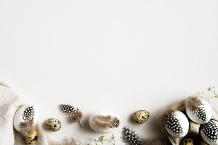 Happy Easter card template. Easter eggs decorated with feathers on white background. Flat lay, top...