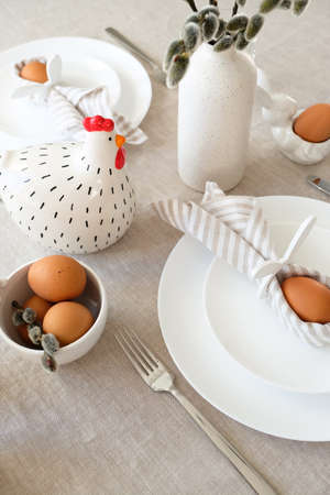 Easter table setting with egg in Easter bunny napkin and cutleryの写真素材