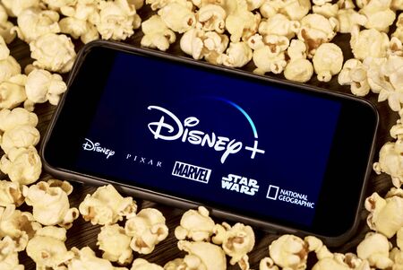 Grand Prairie, TX/USA - Aug 2019: Disney Plus on smartphone with popcorn. Dinsey+ is a new streaming subscription service that will feature Marvel, Pixar, Star Wars, and National Geographic contentのeditorial素材