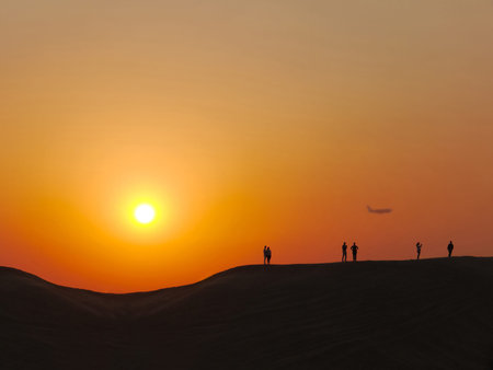 People make photo in the desert at the sunsetの写真素材