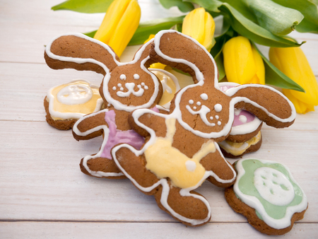Easter Bunny cookies and yellow tulipsの写真素材
