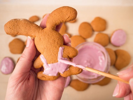 Painting Easter Bunny shaped cookiesの写真素材