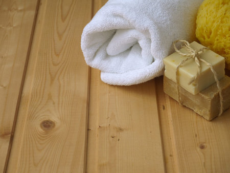 Towel,soap and sponge on the wooden background