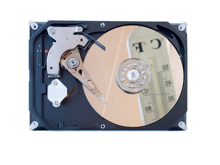 Opened computer hard drive reflecting blurred thermometer isolated on white