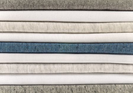 Stack of white, gray and heather blue t-shirts