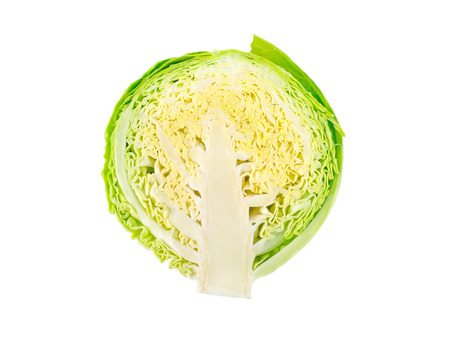 Green cabbage head cut isolated on whiteの写真素材
